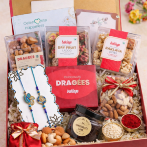 Family Rakhi hamper gift box with designer rakhi, dry fruit ladoos, baklava bites, chocolate dragées, almonds, cashews, chocolate cake jar, roli and chawal.